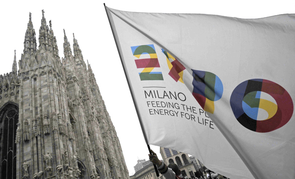 Milan cathedral and in the foreground a flag of the Expo Milano 2015 with the inscription "feeding the people, energy for life".